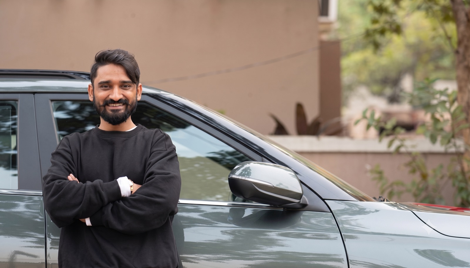 A DashMan beta driver standing beside his car